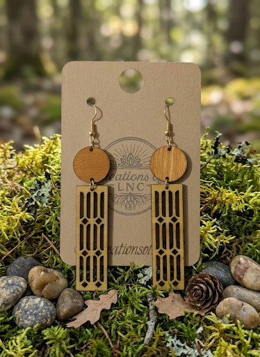 Ready-to-ship handmade wood earrings displayed among moss
